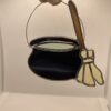 Bubbling witches cauldron and broom